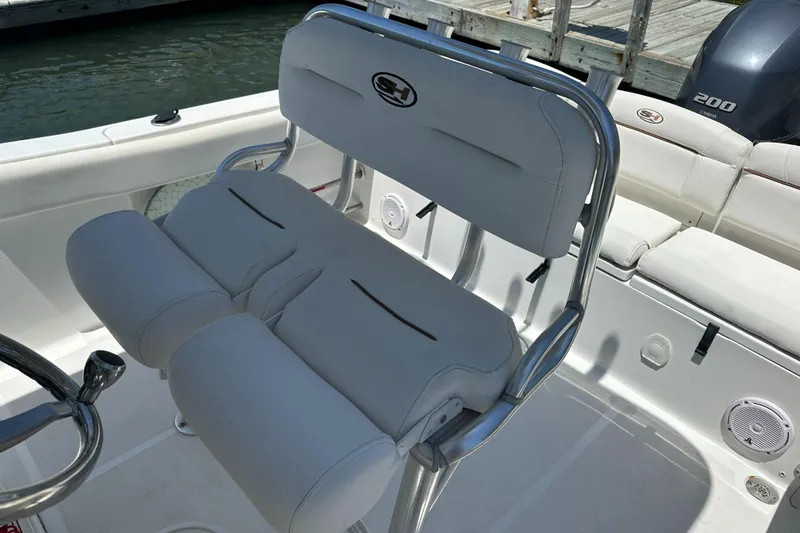 Slide: The Image of 2019 Sea Hunt Ultra 225 boat interior with white seating and stainless steel accents. - 26