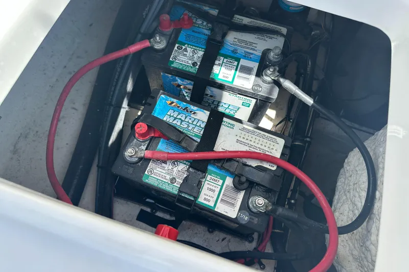 Slide: The Image of Marine batteries in a 2019 Sea Hunt Ultra 225 boat, connected with red and black cables. - 30