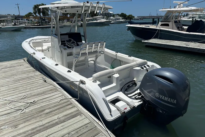 Slide: The Image of 2019 Sea Hunt Ultra 225 boat docked with Yamaha outboard motor. - 4