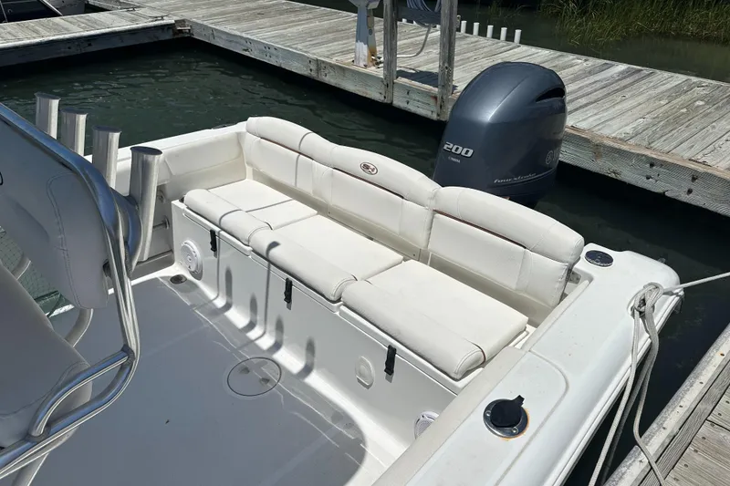 Slide: The Image of 2019 Sea Hunt Ultra 225 boat with white seating and Yamaha engine at dock. - 7