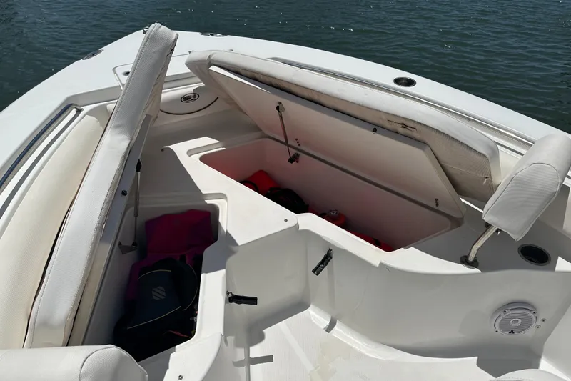 Slide: The Image of 2019 Sea Hunt Ultra 225 boat with open storage compartments on the deck. - 9