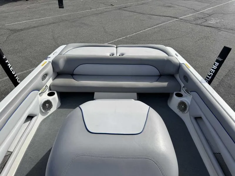 Slide: The Image of Interior of a 2005 Centurion Elite boat with gray seating and speakers. - 10