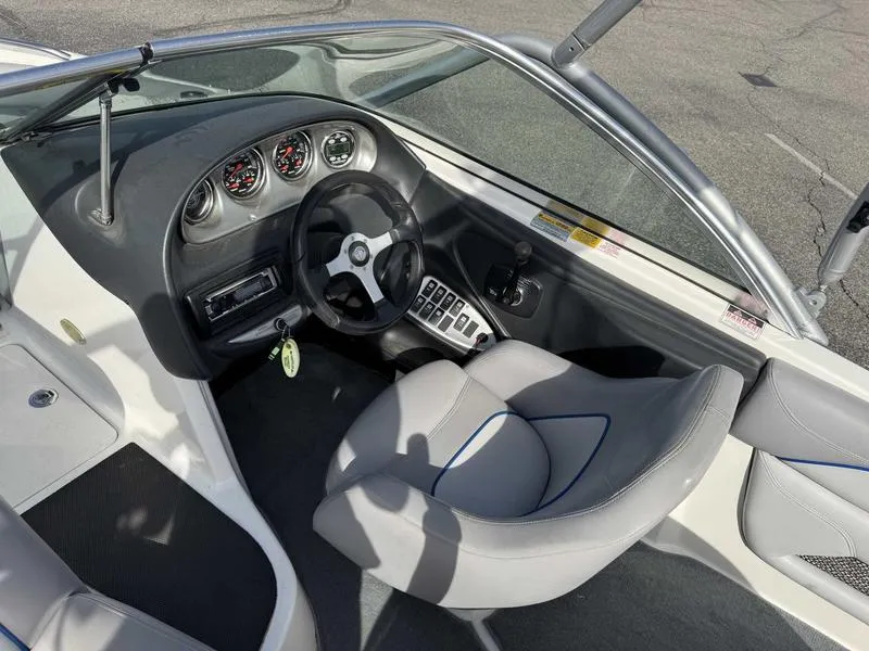 Slide: The Image of 2005 Centurion Elite boat interior with steering wheel, gauges, and seating. - 12