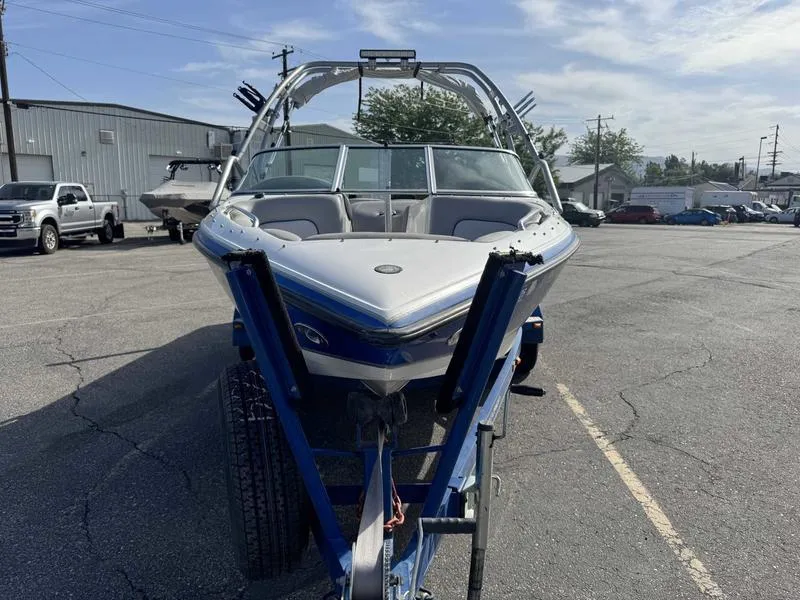 Slide: The Image of 2005 Centurion Elite boat on trailer in parking lot, sunny day. - 2