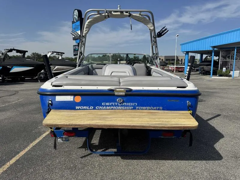 Slide: The Image of 2005 Centurion Elite boat, blue, rear view, parked outdoors, showcasing "World Championship Towboats" branding. - 4