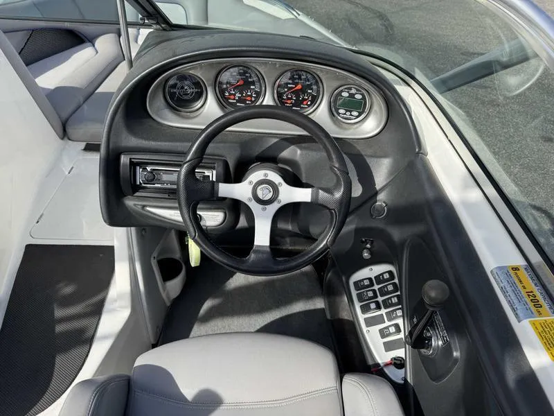 Slide: The Image of 2005 Centurion Elite boat dashboard with steering wheel and control panel. - 9