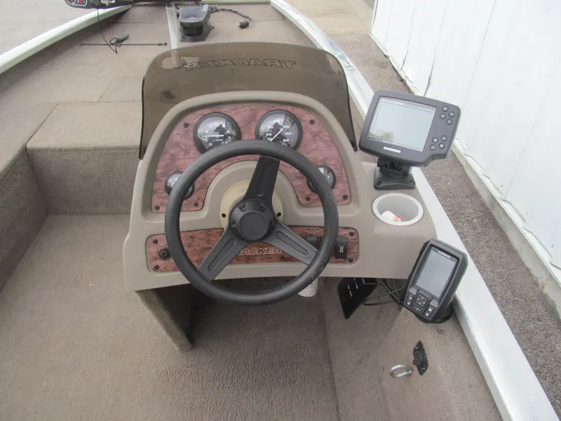 Slide: The Image of 1999 Tracker PRO TEAM 175 SE boat dashboard with steering wheel and electronic displays. - 6