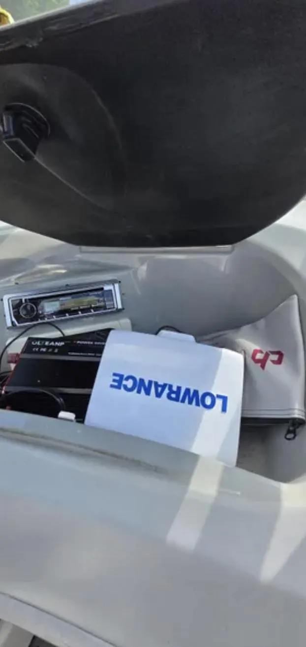 Slide: The Image of Bayliner 205 BR 2006 boat dashboard with Lowrance equipment and stereo system. - 13