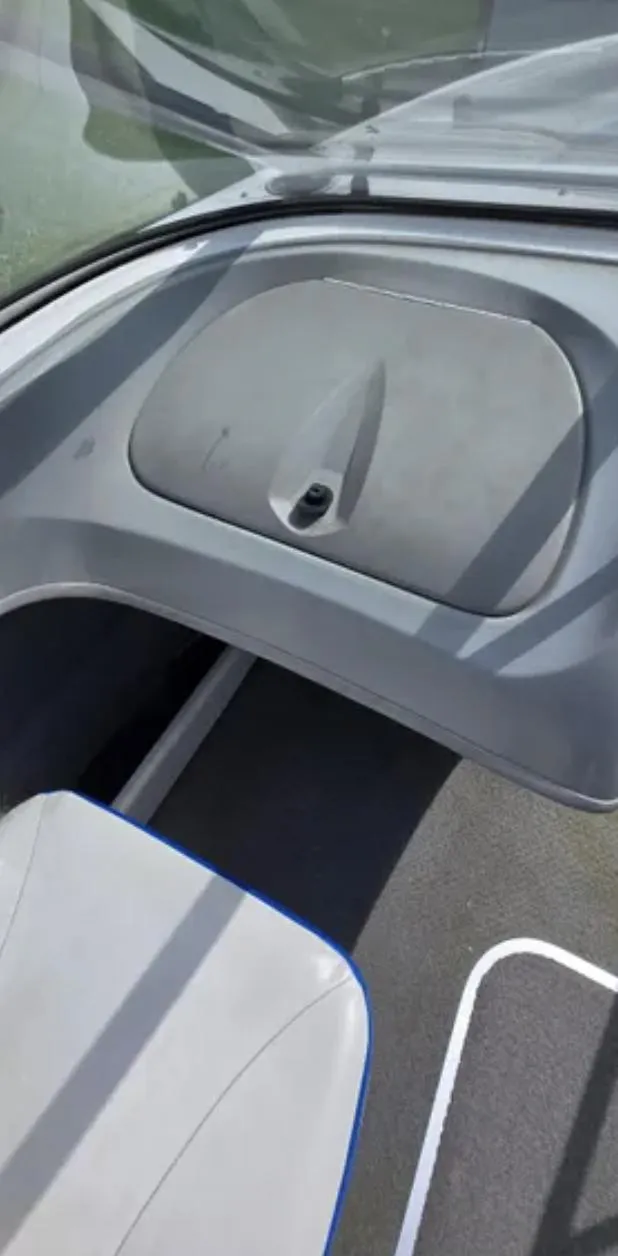 Slide: The Image of Interior view of 2006 Bayliner 205 BR boat, featuring seating and storage compartment. - 14