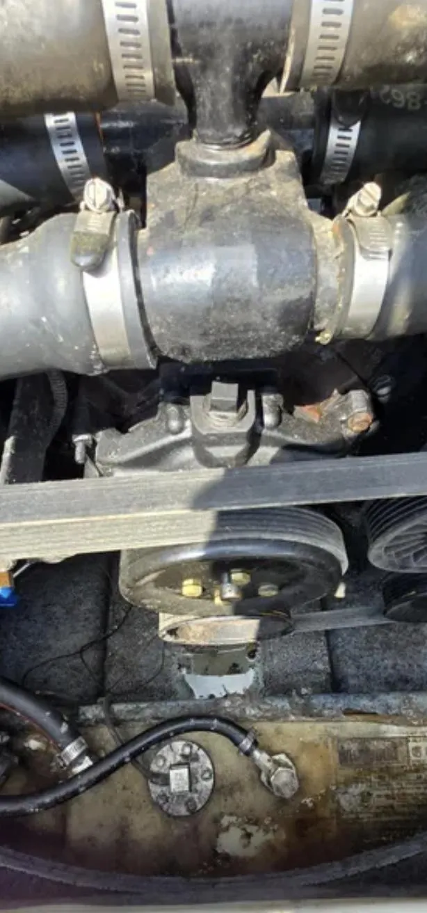 Slide: The Image of Engine components of a 2006 Bayliner 205 BR boat, featuring hoses and pulleys. - 17