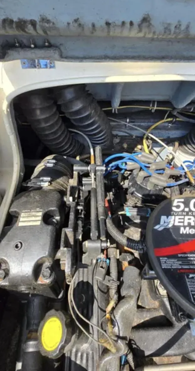 Slide: The Image of Engine compartment of a 2006 Bayliner 205 BR boat, featuring a 5.0 MerCruiser engine. - 18