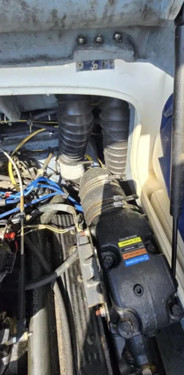 Slide: The Image of Engine compartment of a 2006 Bayliner 205 BR boat, showing mechanical components and hoses. - 19
