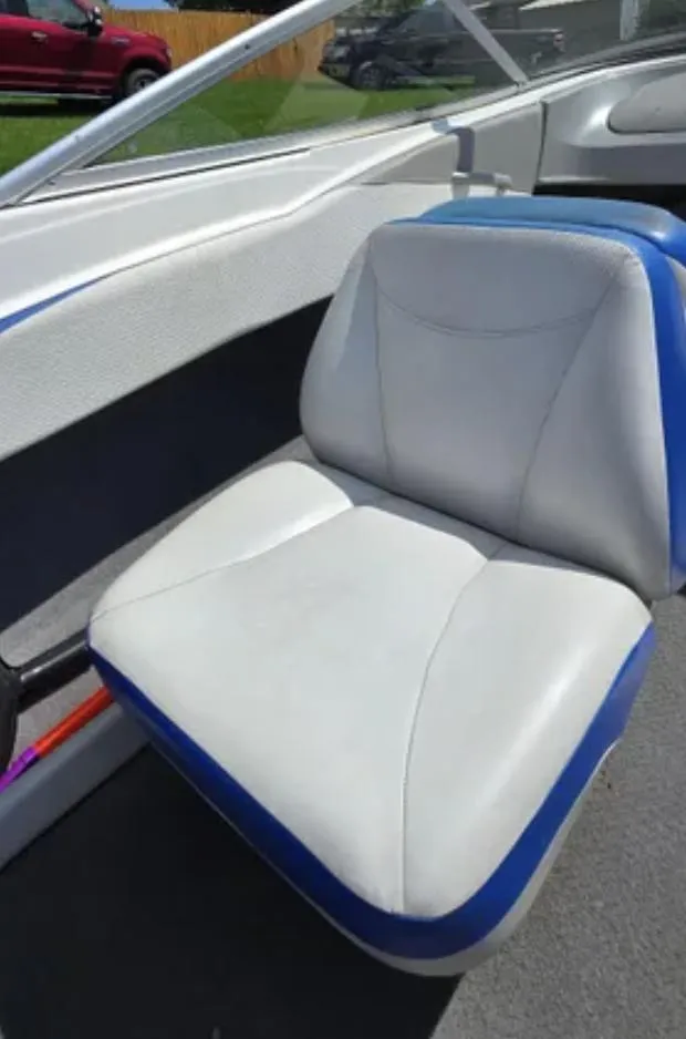 Slide: The Image of 2006 Bayliner 205 BR boat interior seat with white and blue upholstery. - 8