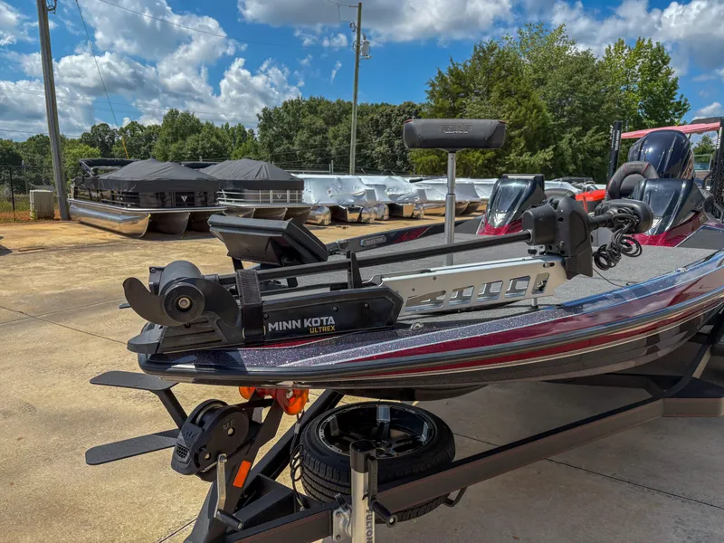 Slide: The Image of 2023 Skeeter FXR 21 Limited boat with Minn Kota Ultrex motor, parked outdoors. - 3