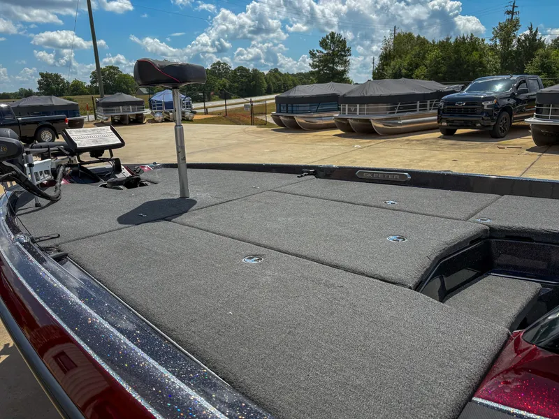 Slide: The Image of 2023 Skeeter FXR 21 Limited boat deck with fishing seat and equipment, under a partly cloudy sky. - 4