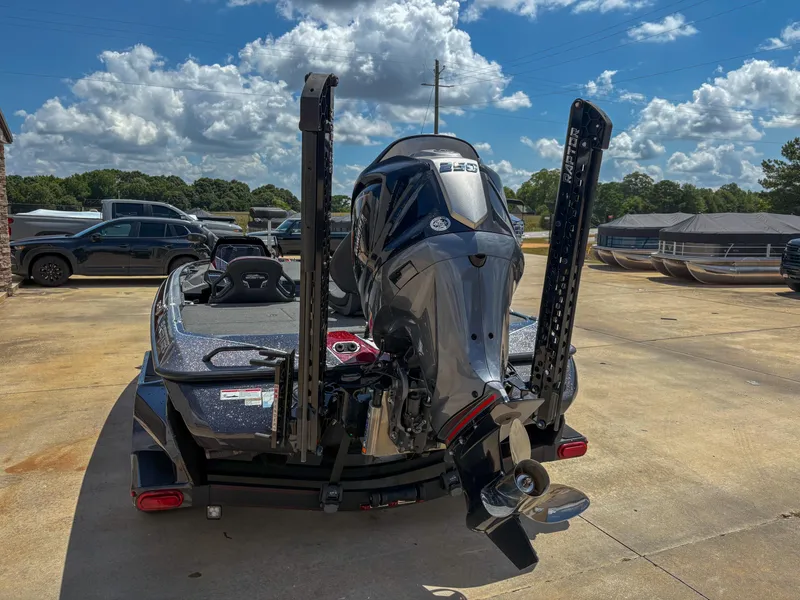 Slide: The Image of 2023 Skeeter FXR 21 Limited boat with powerful outboard motor, parked outdoors. - 7