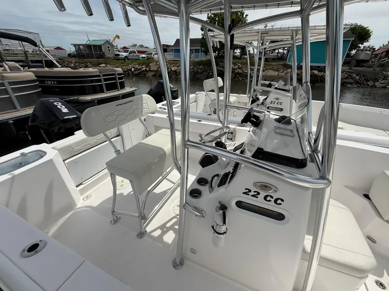 Slide: The Image of 2024 Aquasport 2200 Center Console boat interior with seating and controls. - 6