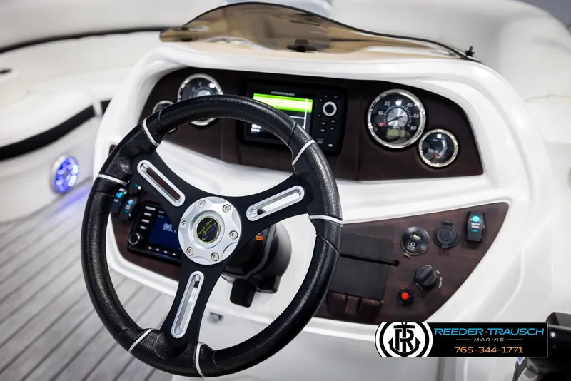 Slide: The Image of Steering wheel and dashboard of 2020 Trifecta 20 RFC CS boat, featuring modern controls. - 31