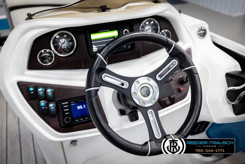 Slide: The Image of Steering wheel and dashboard of 2020 Trifecta 20 RFC CS boat, featuring modern controls. - 32