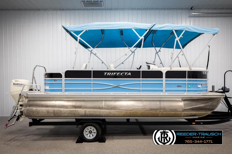 Slide: The Image of 2020 Trifecta 20 RFC CS pontoon boat with blue canopy and Suzuki motor. - 5