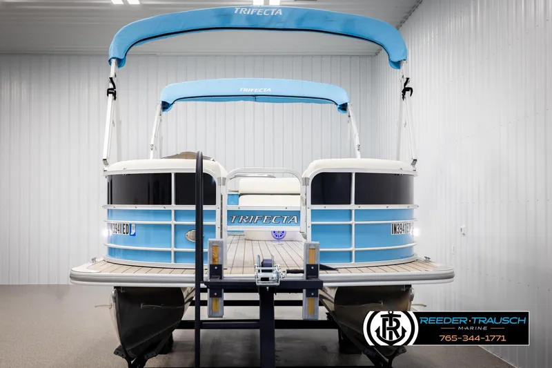Slide: The Image of 2020 Trifecta 20 RFC CS pontoon boat in showroom, blue canopy, Reeder-Trausch Marine. - 8