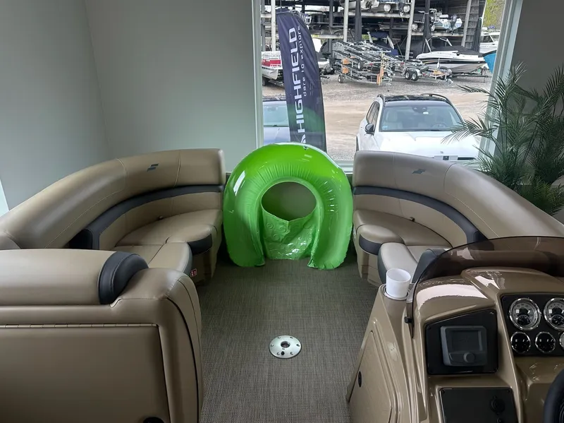 Slide: The Image of Interior of a Starcraft EX 22 R boat with green inflatable. - 13