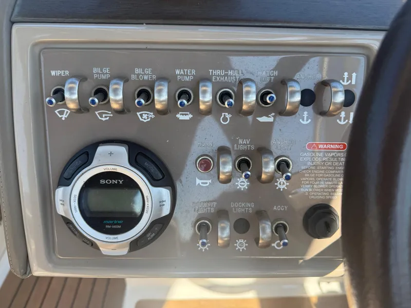 Slide: The Image of Control panel of a 2011 Sea Ray 250 SLX boat with various switches and a Sony marine stereo. - 11