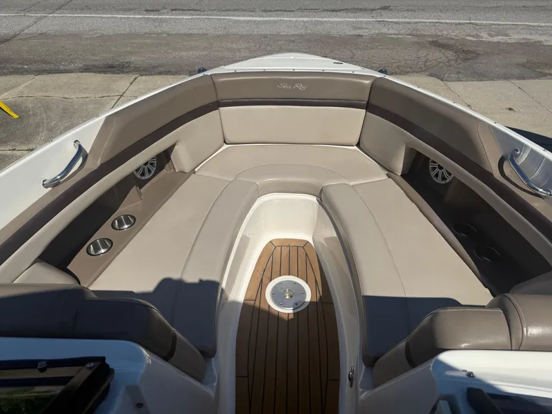 Slide: The Image of 2011 Sea Ray 250 SLX boat interior with beige seating and wood flooring. - 13