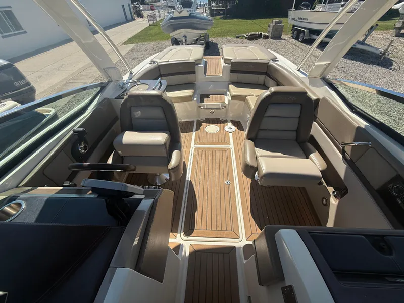 Slide: The Image of Interior of a 2011 Sea Ray 250 SLX boat with luxurious seating and wood flooring. - 15