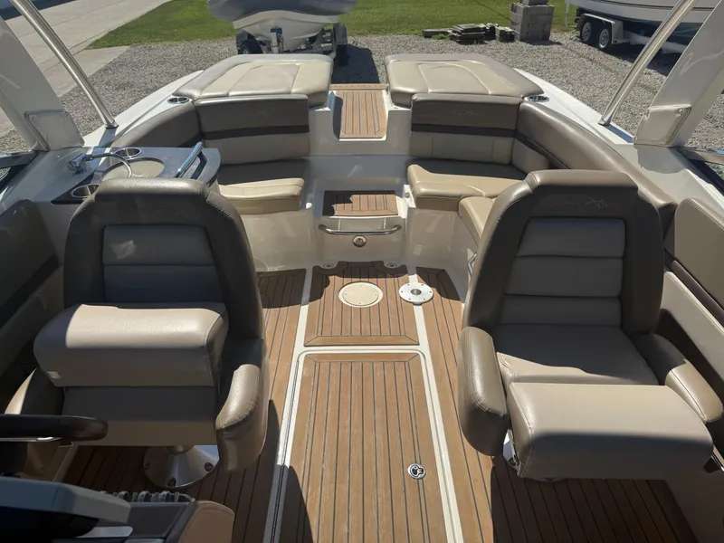 Slide: The Image of Interior of a 2011 Sea Ray 250 SLX boat with luxurious seating and wood flooring. - 16