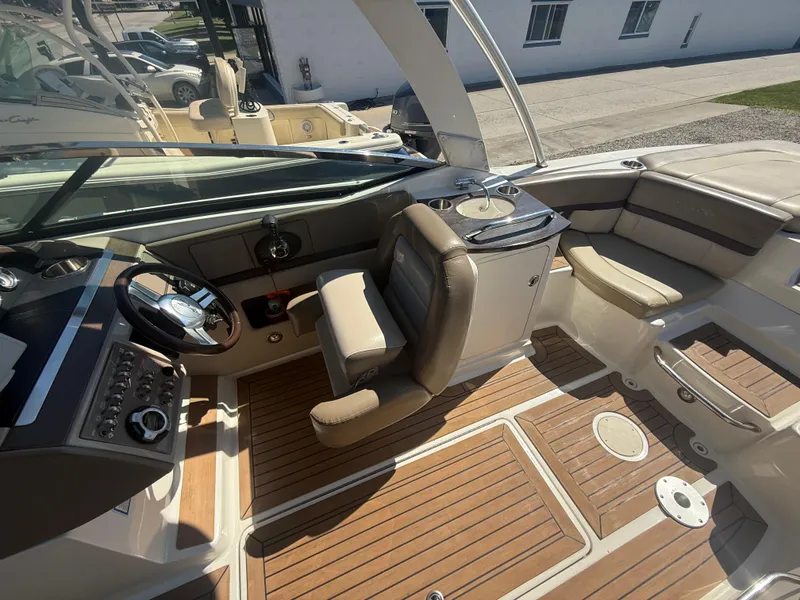 Slide: The Image of 2011 Sea Ray 250 SLX boat interior with helm, seating, and wood flooring. - 18
