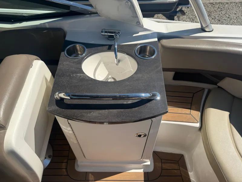 Slide: The Image of Interior of 2011 Sea Ray 250 SLX boat featuring a compact sink and seating area. - 19