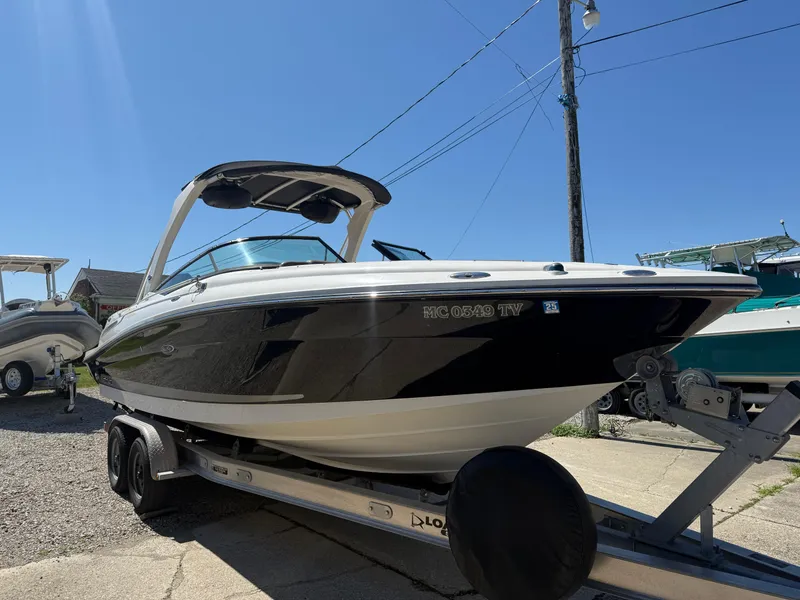 Slide: The Image of 2011 Sea Ray 250 SLX boat on trailer under clear blue sky. - 2