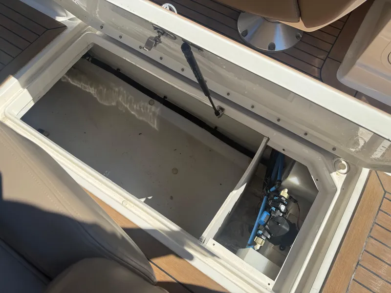 Slide: The Image of Open storage compartment on 2011 Sea Ray 250 SLX boat, showing interior details. - 20