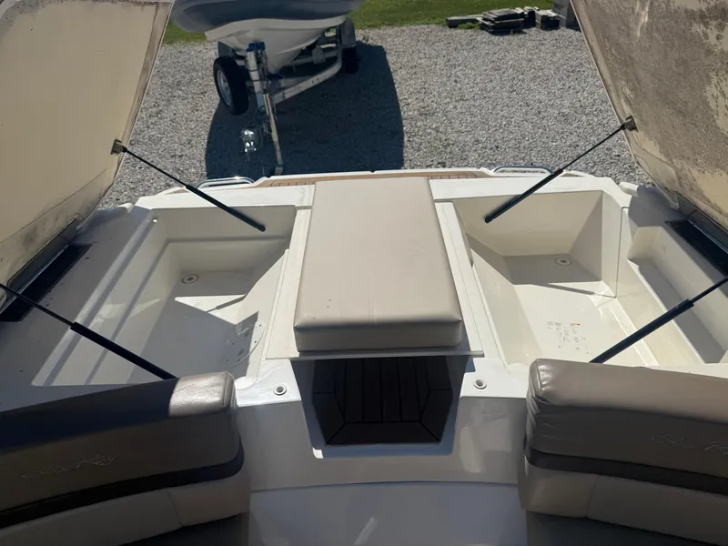 Slide: The Image of 2011 Sea Ray 250 SLX boat interior with open storage compartments. - 25