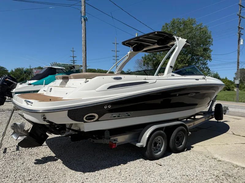 Slide: The Image of 2011 Sea Ray 250 SLX boat on trailer, parked outdoors, sunny day. - 4