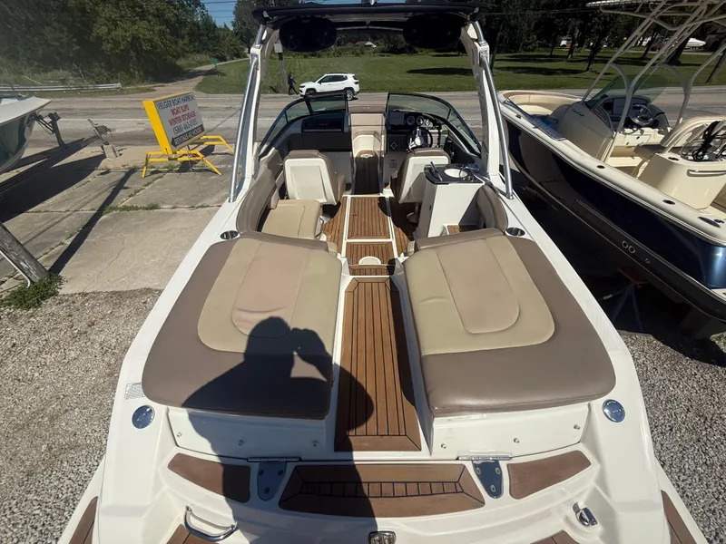 Slide: The Image of 2011 Sea Ray 250 SLX boat interior with tan seating and wooden flooring. - 5