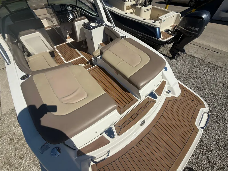 Slide: The Image of 2011 Sea Ray 250 SLX boat interior with tan seating and wood flooring. - 6