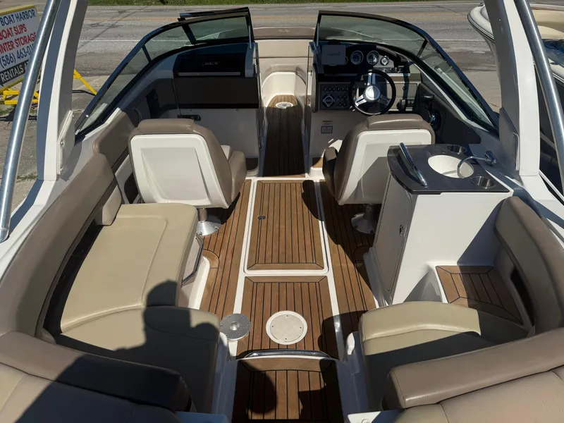 Slide: The Image of 2011 Sea Ray 250 SLX boat interior with beige seating and wood flooring. - 7