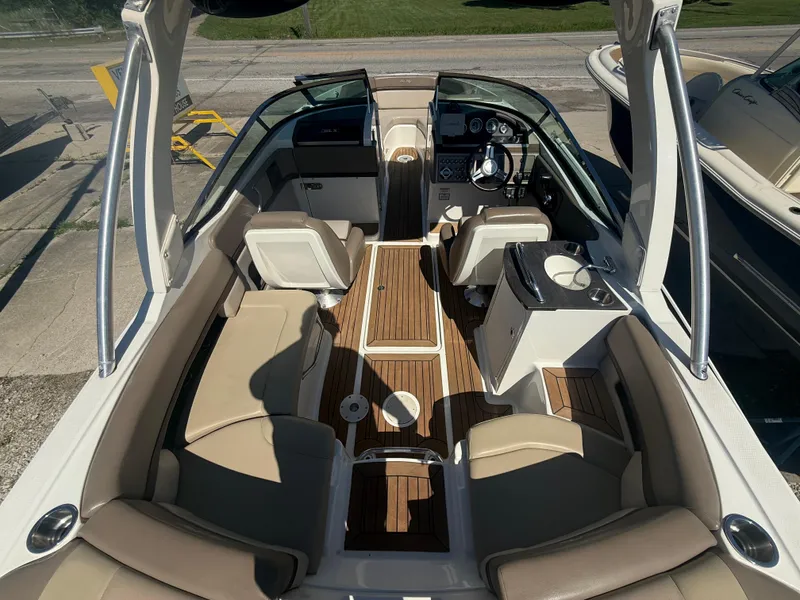 Slide: The Image of 2011 Sea Ray 250 SLX boat interior with beige seating and wood flooring. - 8