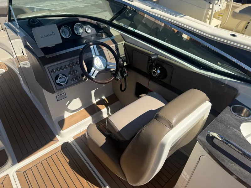Slide: The Image of 2011 Sea Ray 250 SLX boat cockpit with steering wheel and Garmin navigation system. - 9