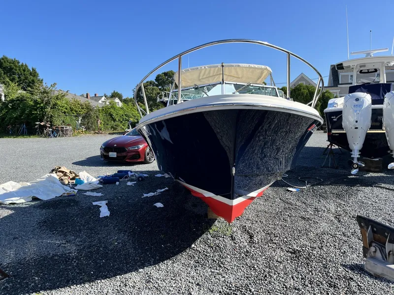 Slide: The Image of 2001 Limestone 24' Express Cruiser on gravel lot, sunny day, surrounded by equipment. - 1