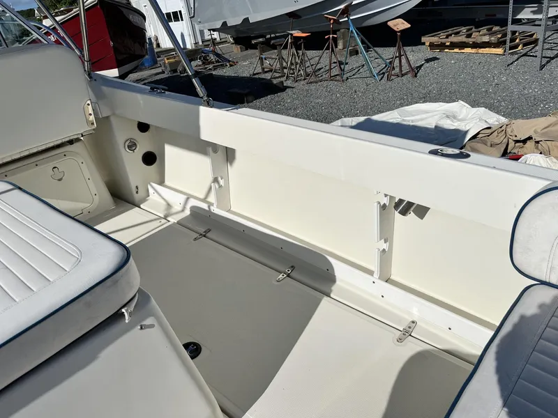 Slide: The Image of 2001 Limestone 24' Express Cruiser interior with white seating and clean deck. - 12