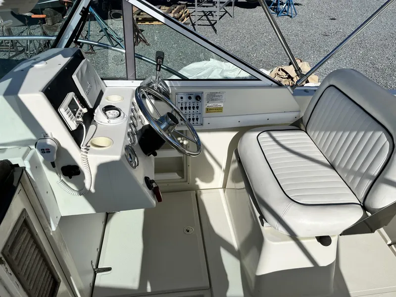 Slide: The Image of 2001 Limestone 24' Express Cruiser cockpit with steering wheel and seating. - 14