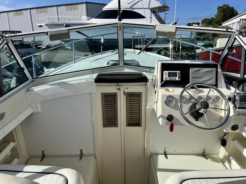Slide: The Image of 2001 Limestone 24' Express Cruiser cockpit with steering wheel and Garmin navigation system. - 15