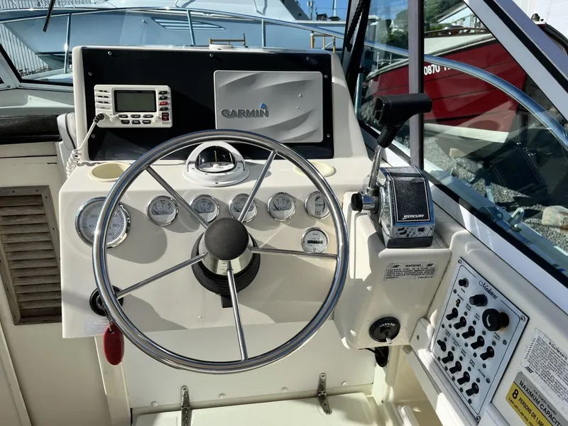 Slide: The Image of Steering console of a 2001 Limestone 24' Express Cruiser with Garmin navigation system. - 16