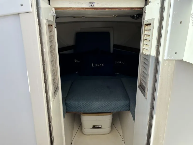 Slide: The Image of 2001 Limestone 24' Express Cruiser cabin interior with blue cushions and storage. - 17