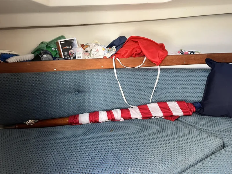 Slide: The Image of Interior of 2001 Limestone 24' Express Cruiser with American flag and assorted items on blue seating. - 19