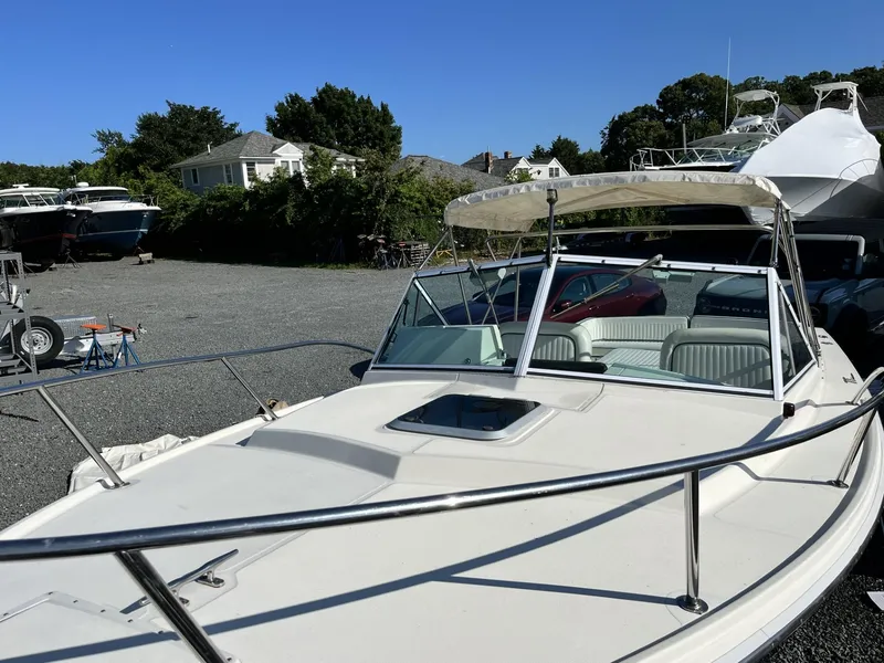 Slide: The Image of 2001 Limestone 24' Express Cruiser in a boatyard under clear blue sky. - 2