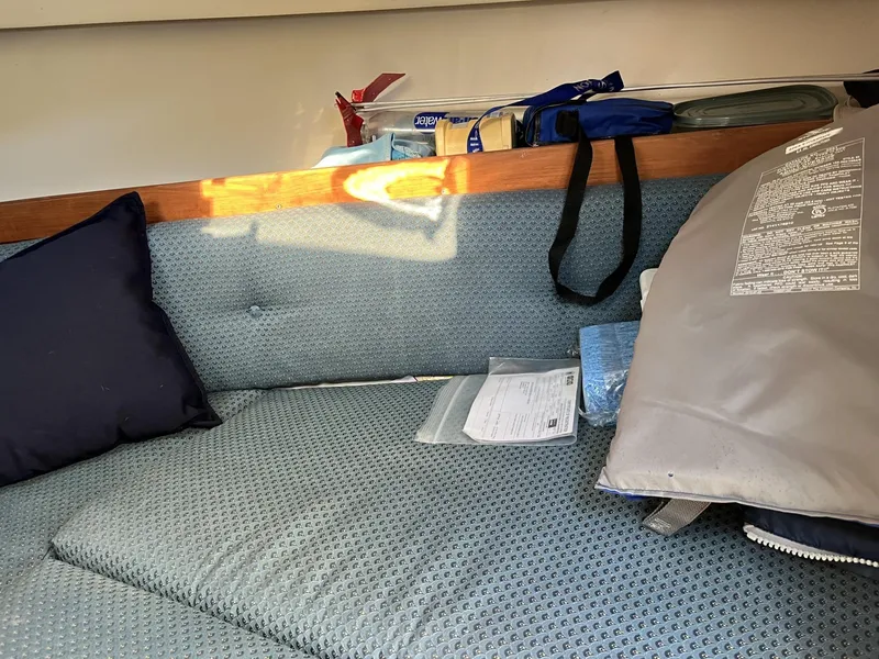 Slide: The Image of Interior of 2001 Limestone 24' Express Cruiser with cushions and storage items. - 20